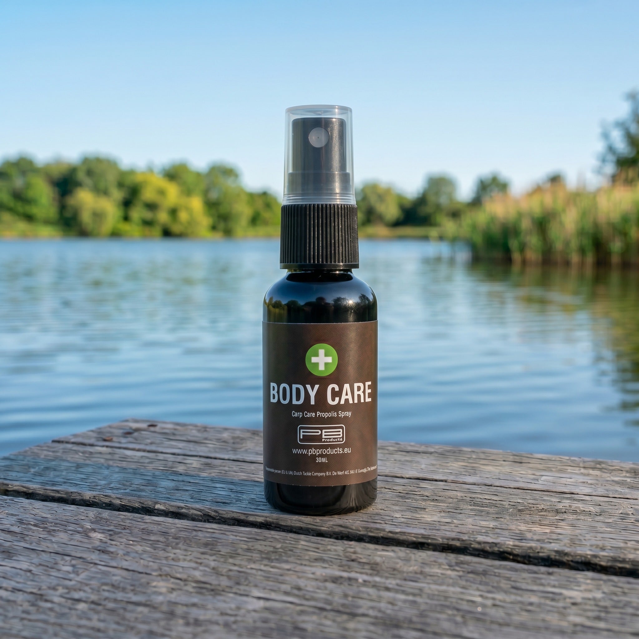PB Products Carp Care Body Care propolis spray 30ml bottle on a wooden lake jetty