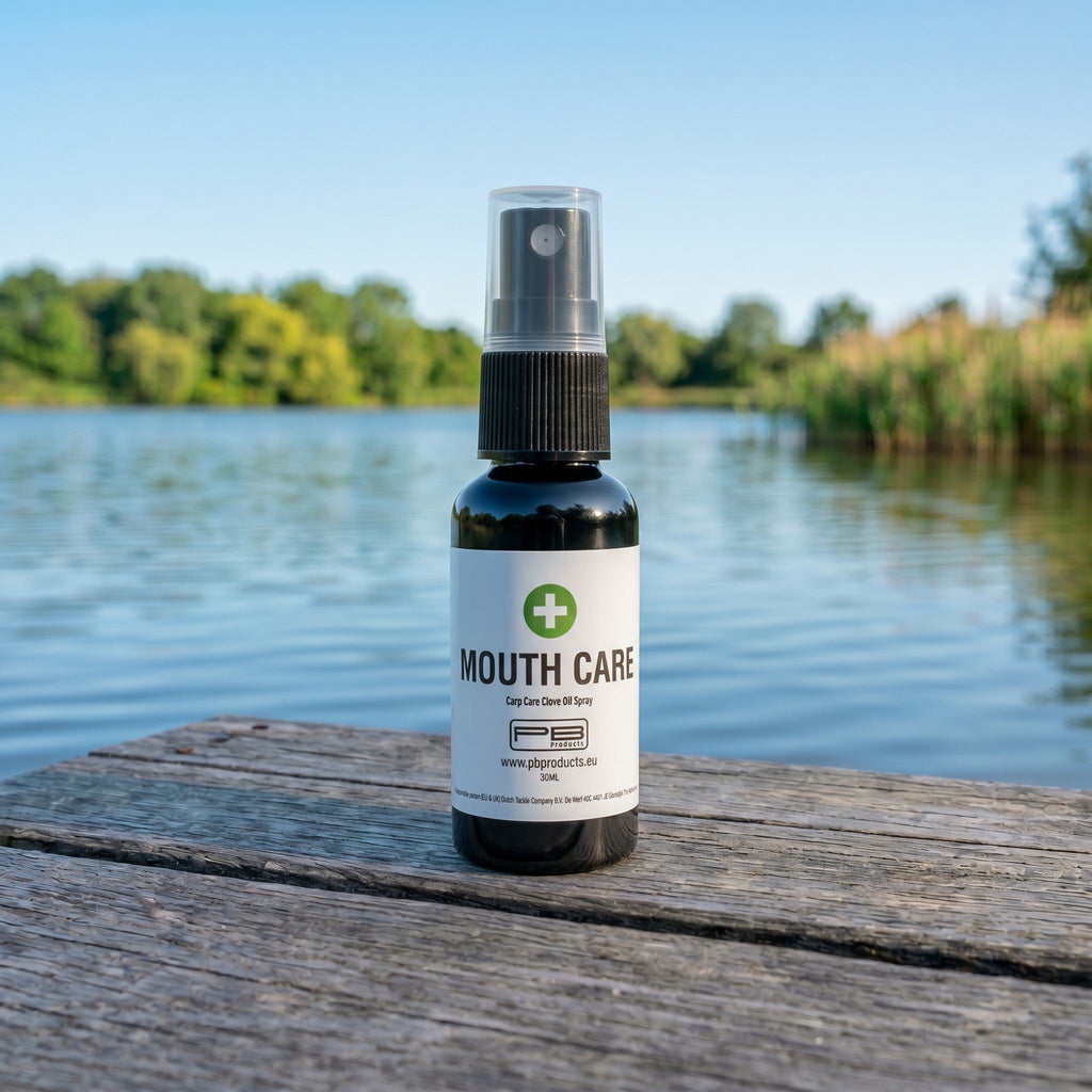 PB Products Carp Care Mouth Care clove oil spray 30ml bottle on a wooden lake jetty